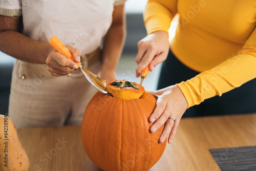 Anonymous friends preparing orange pumpkin at home