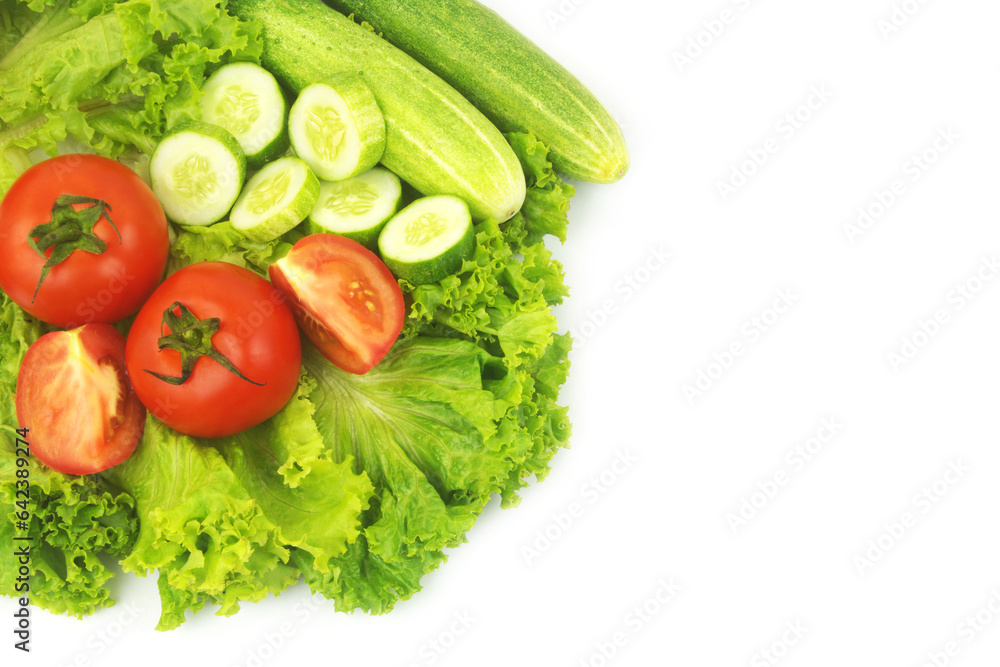 Fresh cucumbers and tomatoes on salad leaves background isolated on white. Fresh cucumbers and tomatoes on salad leaves background isolated on white.