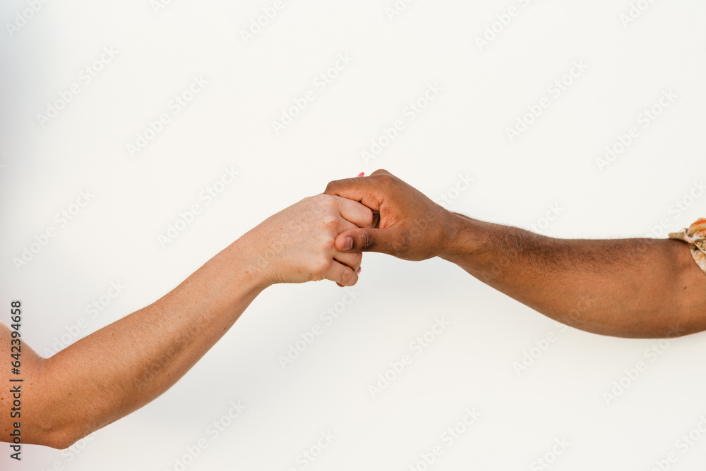 Crop diverse couple giving high five to each other Crop diverse couple giving high five to each other