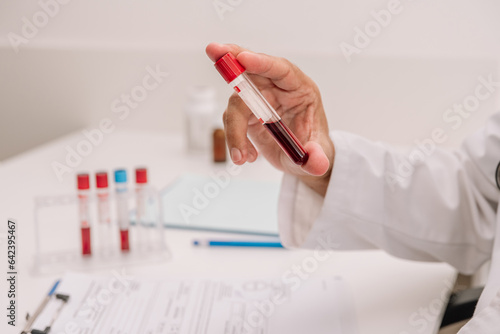Senior man with tube of blood writing result of test photo