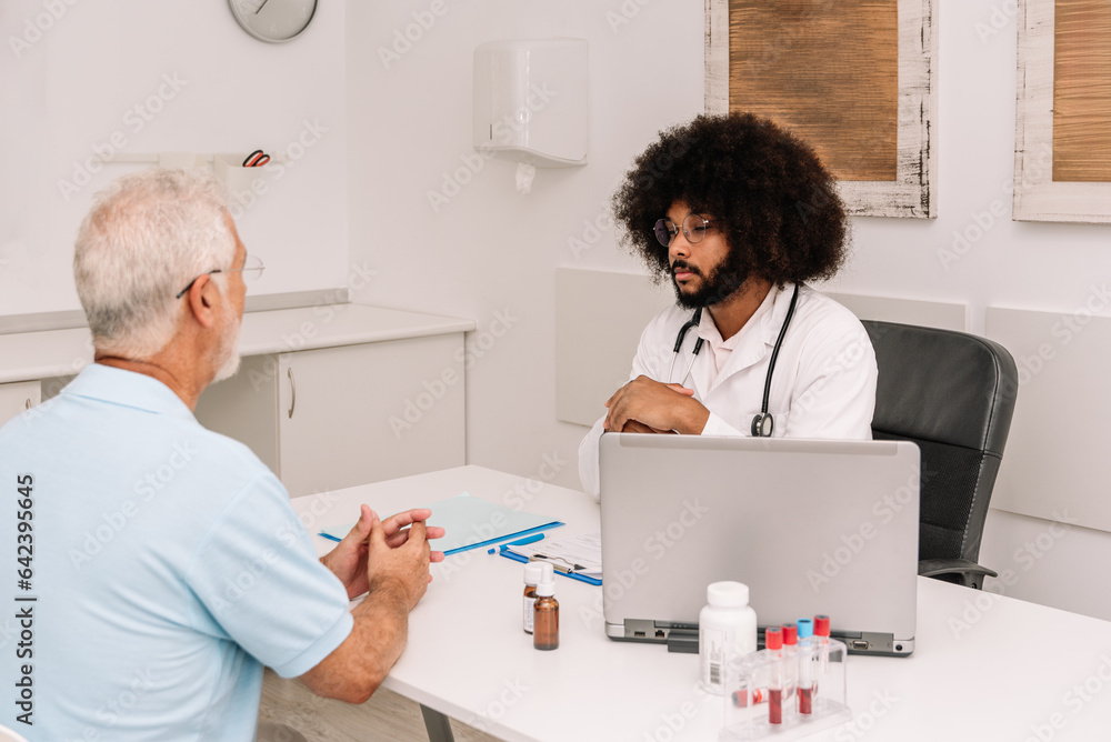 Diverse doctor and patient talking to each other Diverse doctor and patient talking to each other