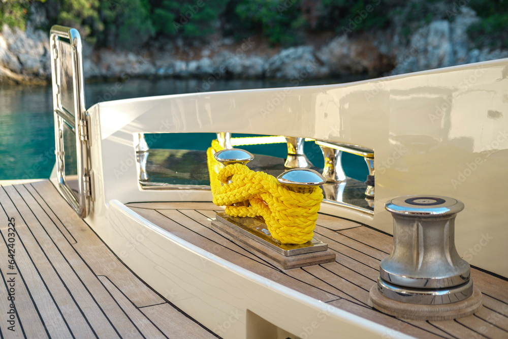 bright yellow rope or lines tied on boat deck cleat, vessel, motor ...