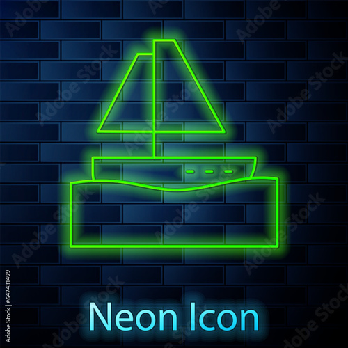Glowing neon line Yacht sailboat or sailing ship icon isolated on brick wall background. Sail boat marine cruise travel. Vector
