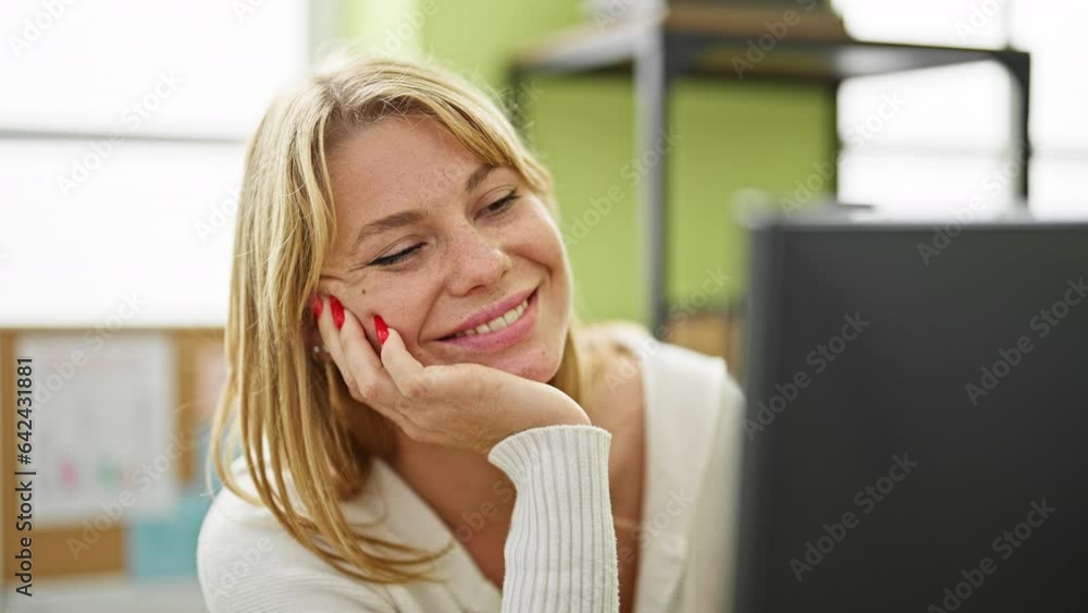 Young blonde woman business worker using computer working at office Young blonde woman business worker using computer working at office