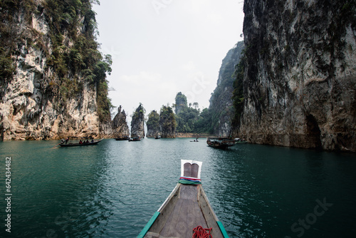 Discover Khao Soks Natural Wonders Serene Long Tail Boat Journey Amidst Turquoise Waters  Jagged Peaks in Thailands Wilderness © Joel