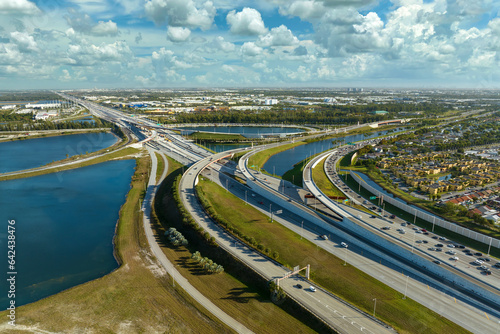 USA transportation infrastructure concept. Above view of wide highway crossroads in Miami, Florida with fast driving cars