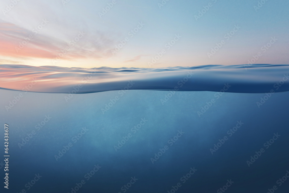 Blue sea or ocean water surface and underwater against sunset.