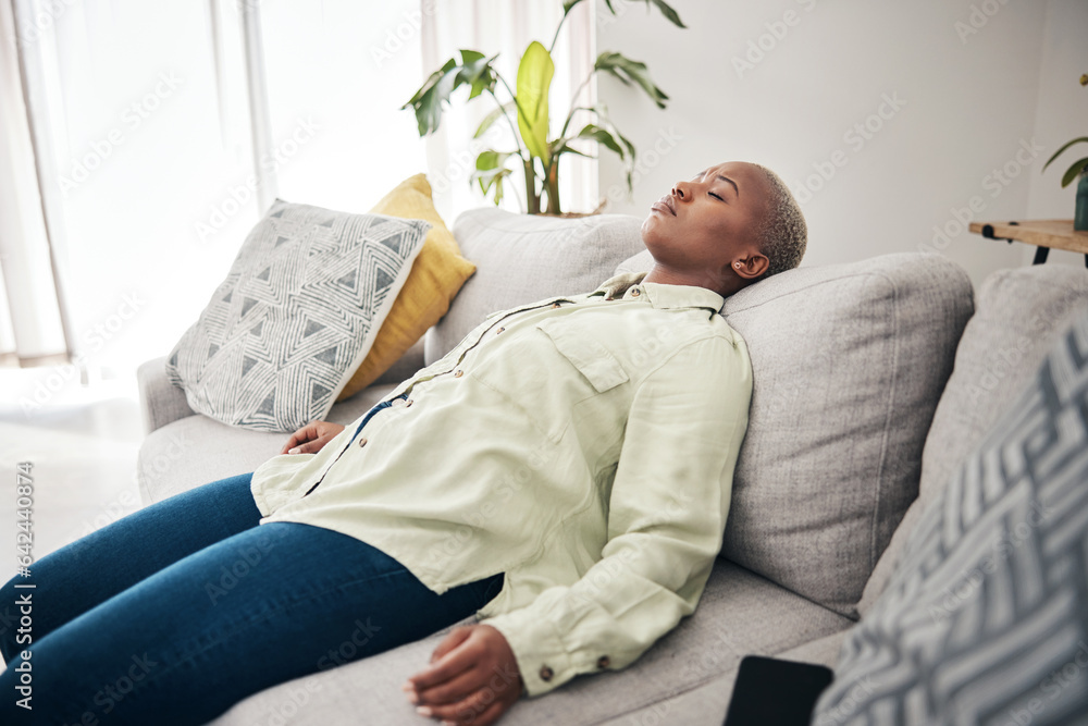 Tired, sleep and black woman on a home sofa for relax, stress relief or lazy after work. Mental health, living room and an African girl on a couch for rest, sleep or burnout with insomnia or fatigue