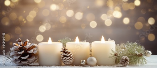 Christmas and winter decorations including white candles fir branches cones and wreaths Symbolizes New Year and holiday season