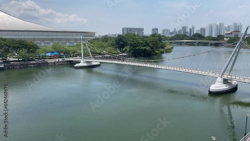 View from above on the Tanjong Rhu Suspension Bridge in Singapore overlooking city's skyline photo