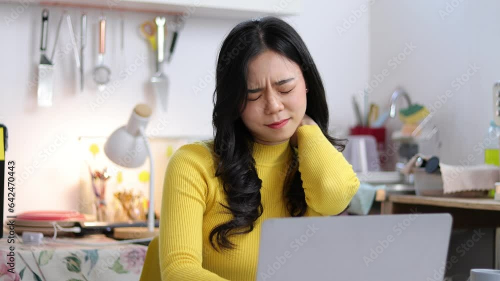 Asian woman working on laptop from home. Sick woman having pain and discomfort. Asian woman working on laptop from home. Sick woman having pain and discomfort.