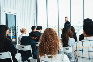 Group of business people meeting in a seminar conference . Audience listening to instructor in employee education training session . Office worker community summit forum with expert speaker . Jivy