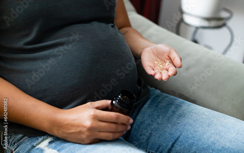 The use of pills during pregnancy  female belly  female body supplementation