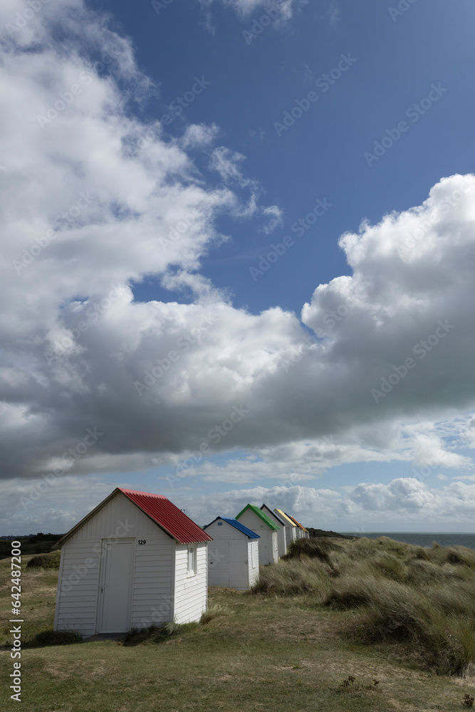 Beach cabins and seashore in Gouville sur Mer, Manche, Normandy, France in various lights