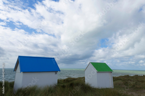 Beach cabins and seashore in Gouville sur Mer, Manche, Normandy, France in various lights photo