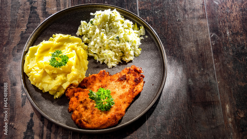 Foto Chicken cutlet coated with breadcrumbs with potatoes and cabbage