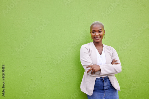 Portrait, fashion and black woman smile with arms crossed on green wall background mockup space. Positive designer, happy and confident African person in style, casual clothes and trendy in Nigeria