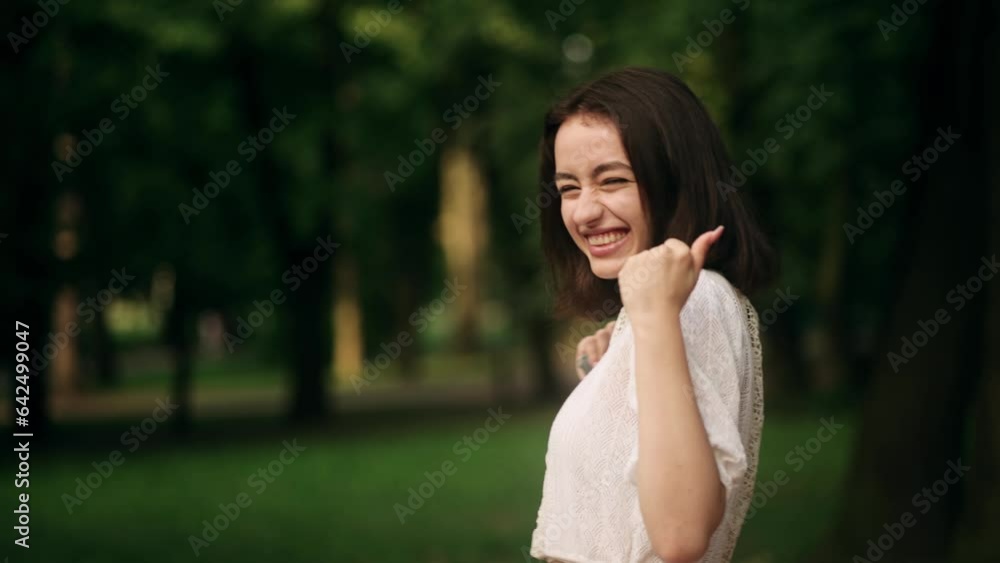 Pretty young woman in the green city centre get notification and celebrate online win success reading great news message feel amazed happy outdoors Pretty young woman in the green city centre get notification and celebrate online win success reading great news message feel amazed happy outdoors