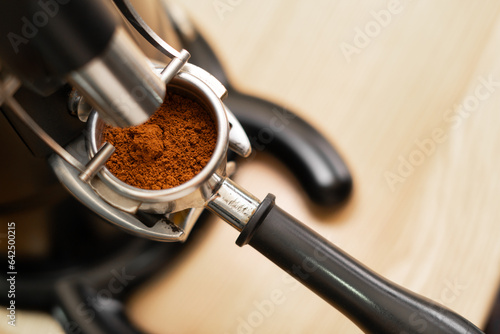 coffee grinder grinding coffee pouring into a portafilter photo
