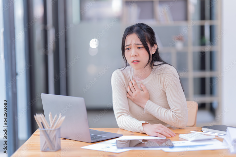 Young business woman manager, holding accounting bookkeeping documents checking financial data or marketing report working in office with laptop. Paperwork management Young business woman manager, holding accounting bookkeeping documents checking financial data or marketing report working in office with laptop. Paperwork management