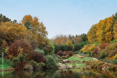 View of beautiful autumn park with lake and trees