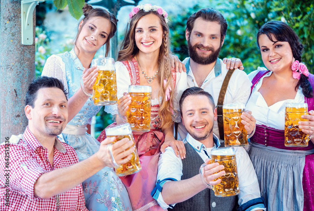 Group of merry people drinking beer holding the glasses into the camera Group of merry people drinking beer holding the glasses into the camera
