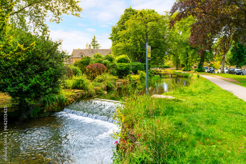 The scenic River Eye as it runs along the main street through the charming Cotswold Village of Lower Slaughter, in the Gloucestershire region of England, UK.