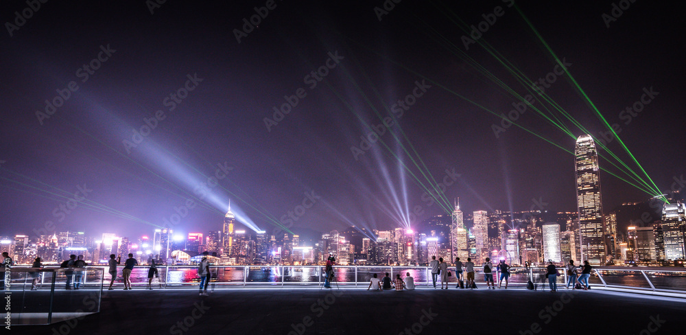 laser show over hong kong city at night