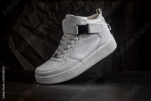 White sneakers on a black background