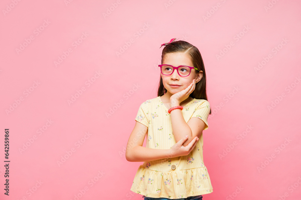 Smart little girl thinking about a new idea Smart little girl thinking about a new idea