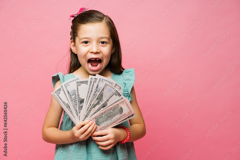 Surprised excited litle kid with a lot of money Surprised excited litle kid with a lot of money