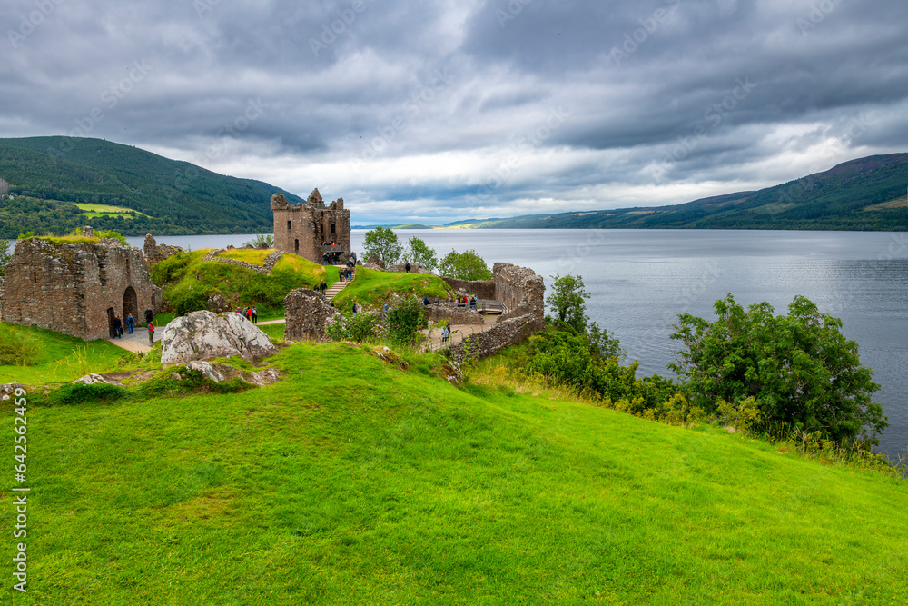 The medieval ruins of the hilltop Urquhart Castle fortification along the shores of Loch Ness lake near Inverness, Scotland, in the Scottish Highlands.