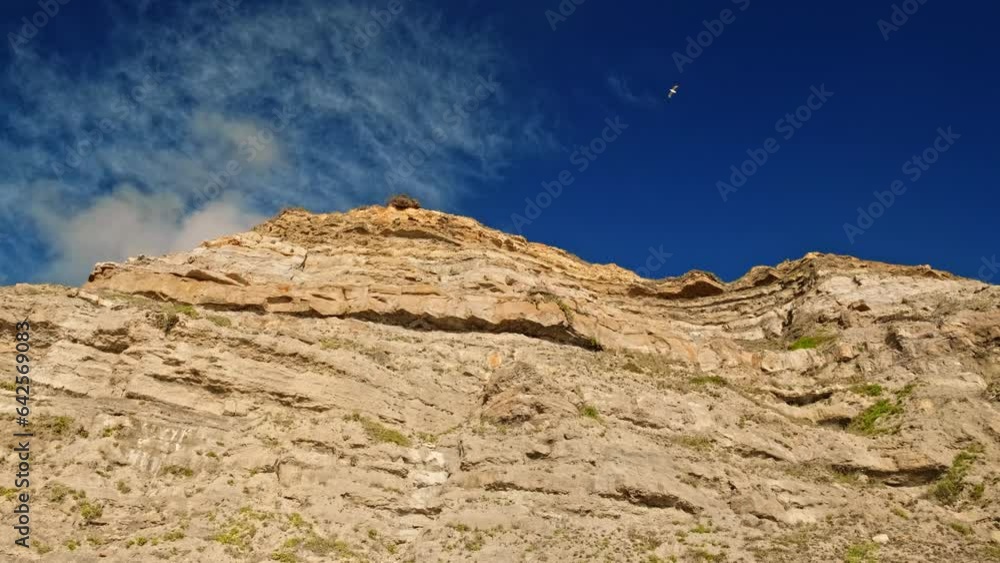 Beautiful rocky shore with a blue sky and white clouds. Beautiful summer coastal landscape. Rocky coast of the Atlantic Ocean on a bright sunny day. Peaceful Wild nature. Slow motion panning shot. Beautiful rocky shore with a blue sky and white clouds. Beautiful summer coastal landscape. Rocky coast of the Atlantic Ocean on a bright sunny day. Peaceful Wild nature. Slow motion panning shot.