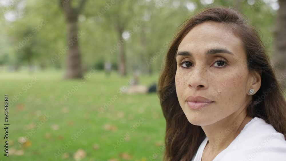 Attractive female turns to camera and smiles, in slow motion Attractive female turns to camera and smiles, in slow motion