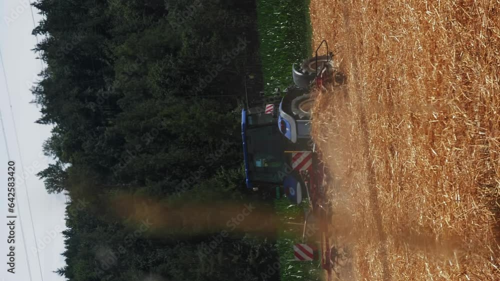 Combine tractor working in field. Vertical video. Harvester collecting crop Combine tractor working in field. Vertical video. Harvester collecting crop
