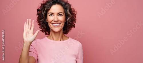 Smiling woman happily wavin...