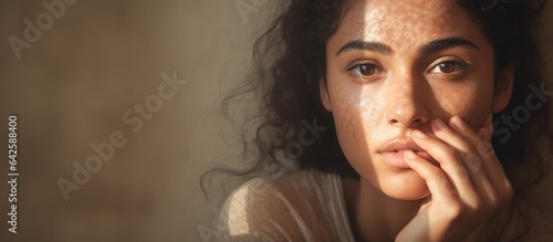 Digital composite of an Indian woman checking her reflection on International Skin Pigmentation Day with text and copy space Emphasizing skincare awareness and treatment for pigmentation