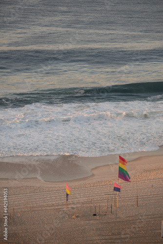 Rio de Janeiro, Brazil: early morning and rainbow flags on a desert Copacabana beach, one of the famous beaches of the city, named after the Virgen de Copacabana, patron saint of Bolivia photo