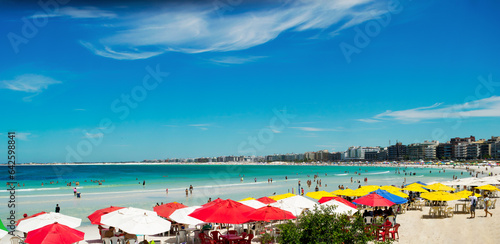 Beautiful view of Praia do Forte, with the city in the background, people on the white sand beach, blue sky and sea - 14