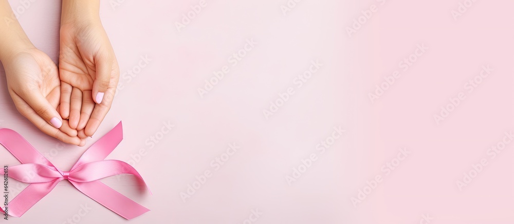 Pink ribbon held by a small girl in background Breast cancer awareness month Women s Day and World Cancer Day theme Copy space Panoramic