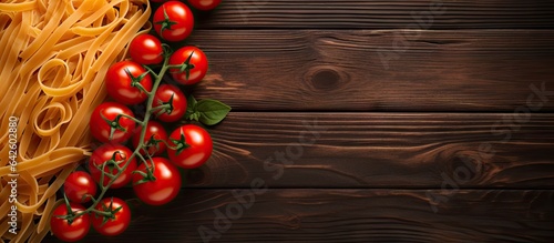 Raw pasta and tomatoes on w...