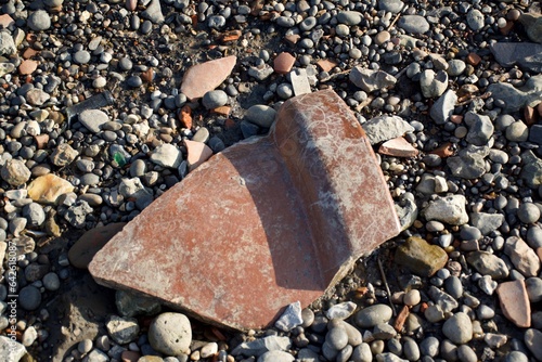 Broken clay pot on the stoney beach photo