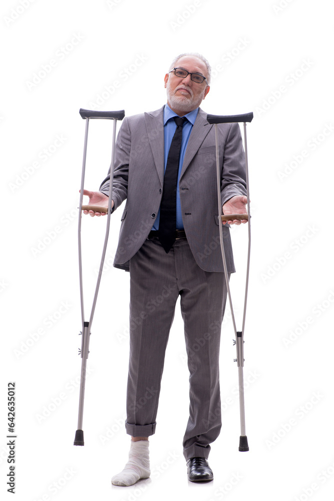 Old businessman with crutches isolated on white Old businessman with crutches isolated on white