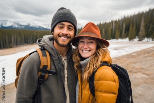 Couple in their 30s smiling at the Yellowstone National Park in Wyoming USA