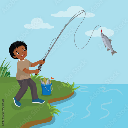 Cute little African boy fishing at the river catching big fishes 