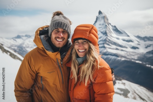 Couple in their 30s smiling at the Matterhorn in Valais Switzerland