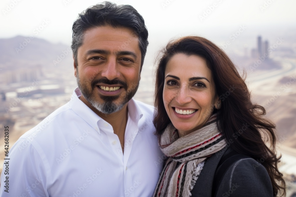 Couple in their 40s smiling at the Mecca in Saudi Arabia Couple in their 40s smiling at the Mecca in Saudi Arabia