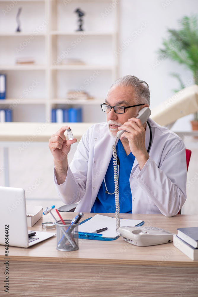 Old male doctor in telemedicine concept Old male doctor in telemedicine concept