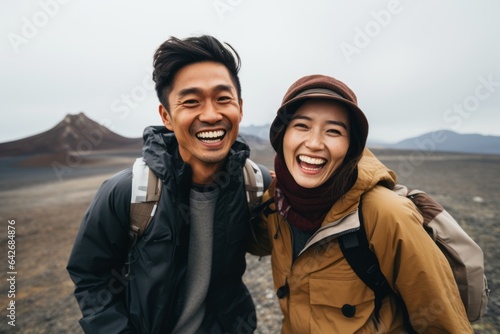 Couple in their 30s smiling at the Aogashima Volcano in Tokyo Japan photo