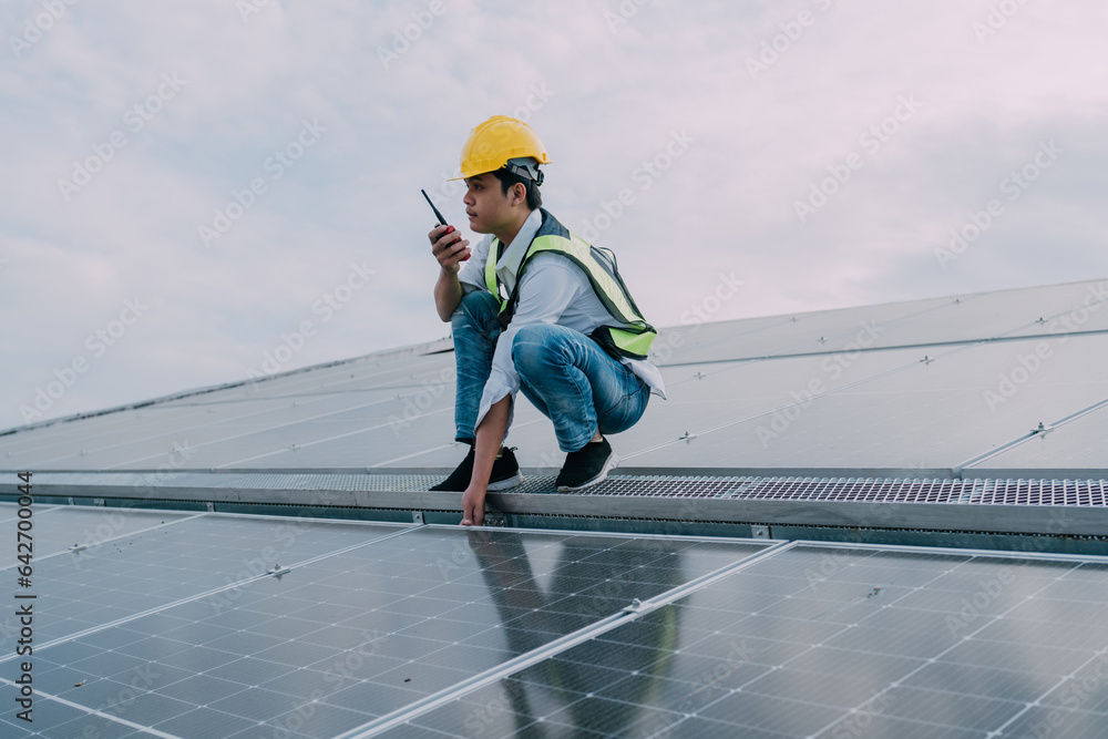 Engineers wearing a uniform walking on roof inspect and check solar cell panel, solar cell is smart ecology energy sunlight alternative power factory concept. Engineers wearing a uniform walking on roof inspect and check solar cell panel, solar cell is smart ecology energy sunlight alternative power factory concept.